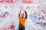 Pato O'Ward celebrates on the podium after winning the 2025 IndyCar Ontario Honda Dealers Indy Toronto - Source: Getty