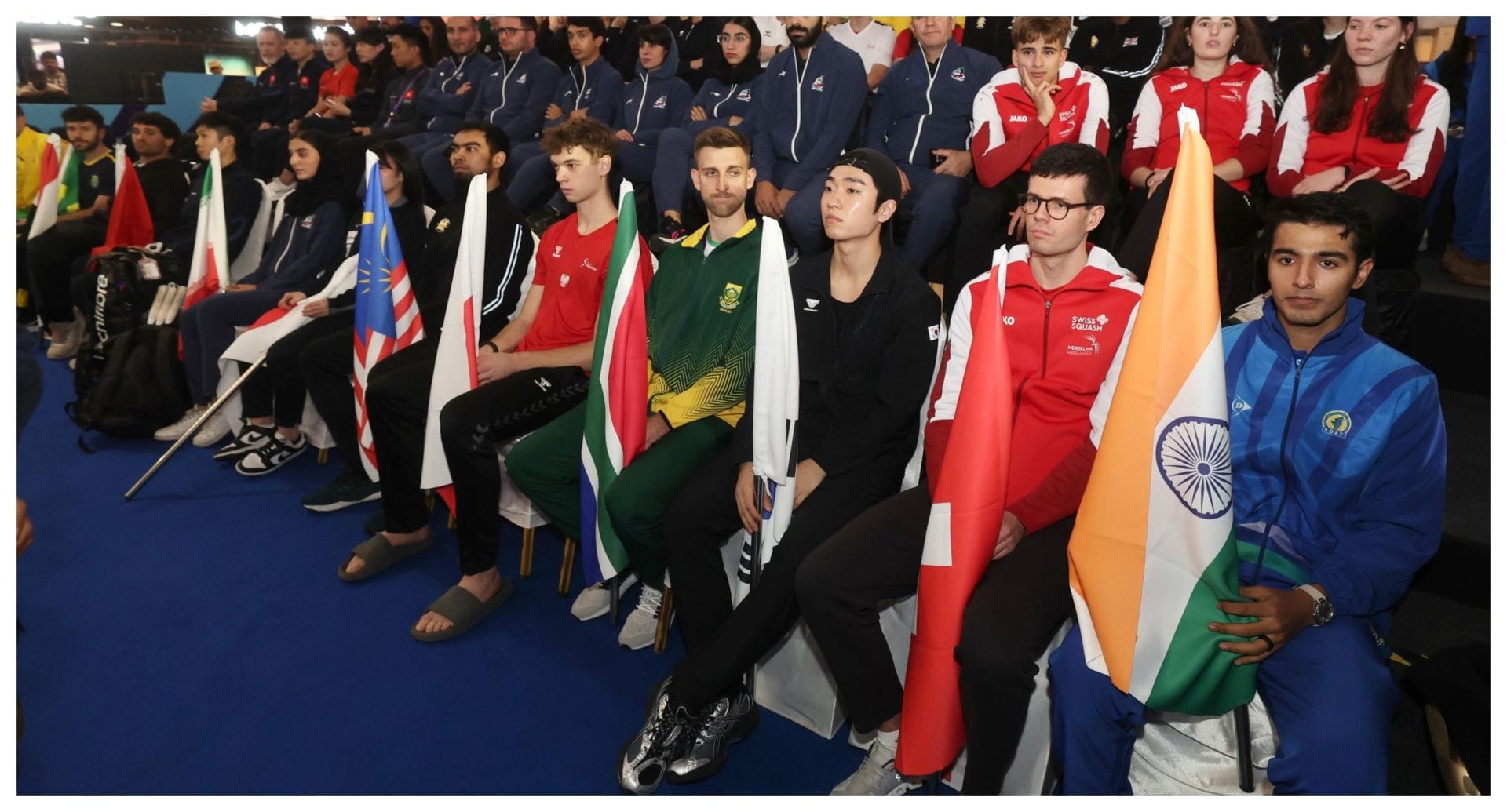 The teams with their respective flags at the Squash World Cup - source: Udhaystalin on X