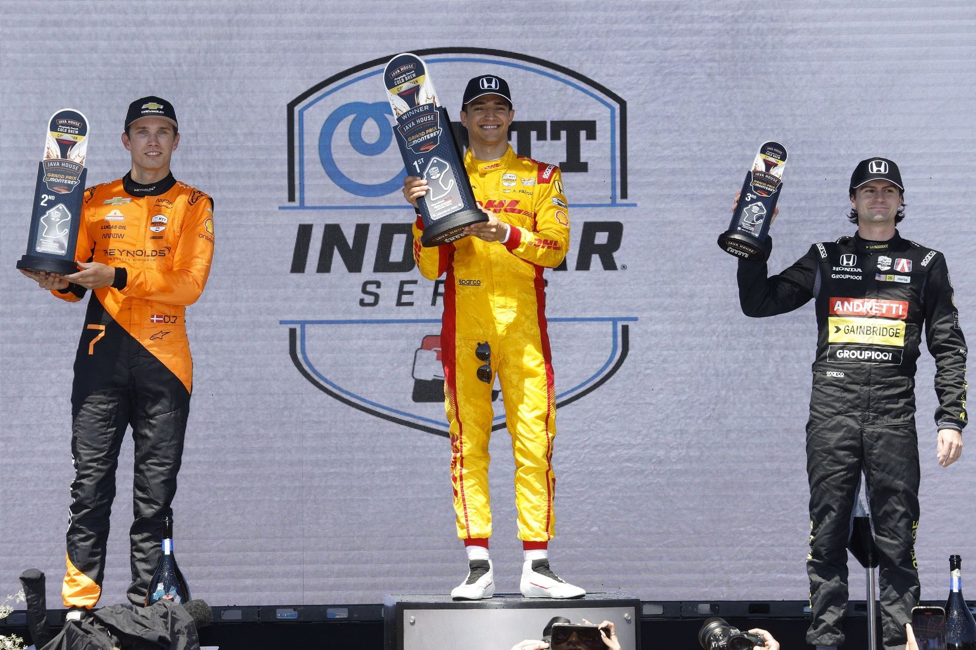 Christian Lundgaard, Alex Palou, and Colton Herta on the podium at the 2025 INDYCAR Java House Grand Prix of Monterey - Source: Getty