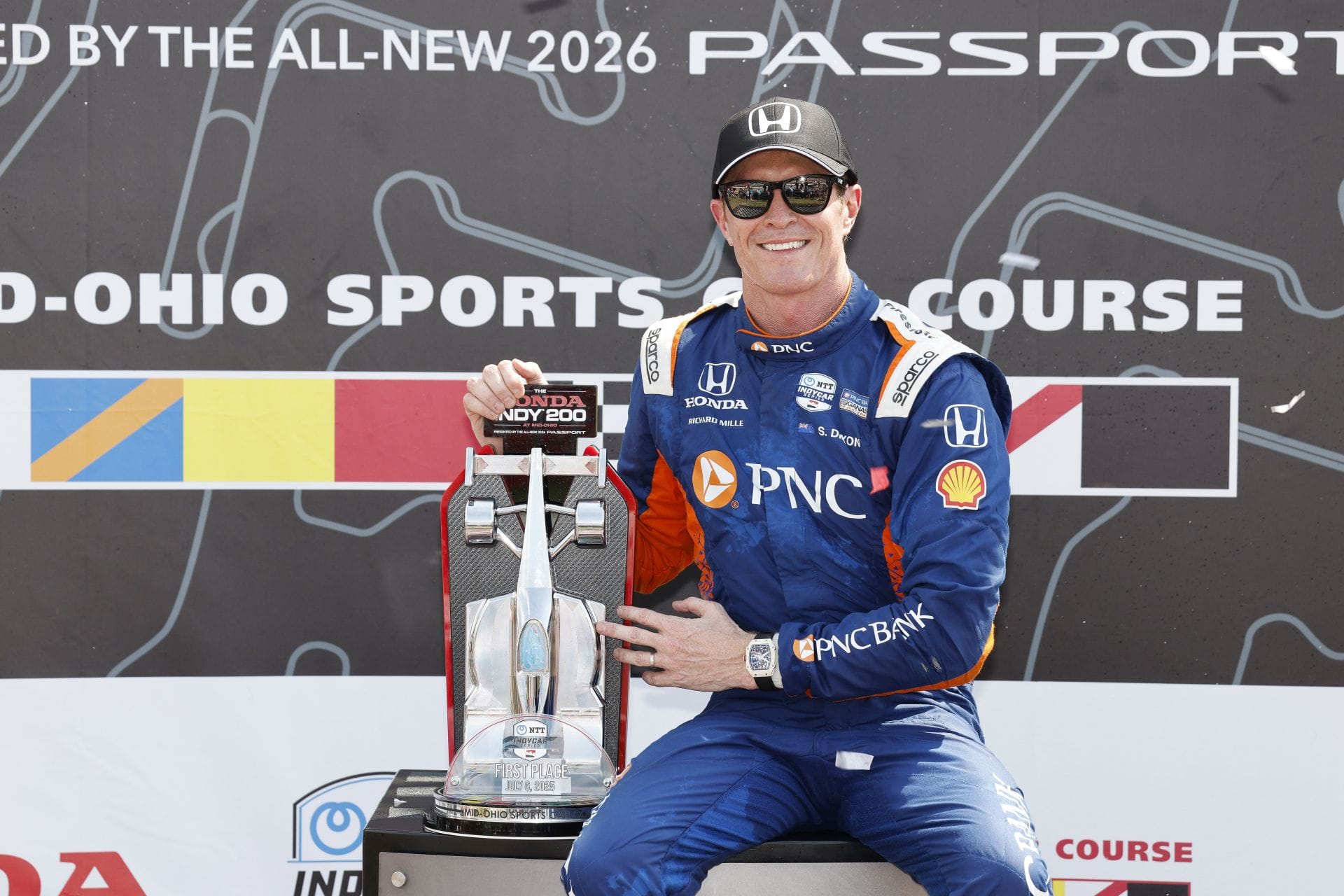 Scott Dixon poses with the winner's trophy after the 2025 NTT IndyCar Series Honda Indy 200 at Mid-Ohio - Source: Getty