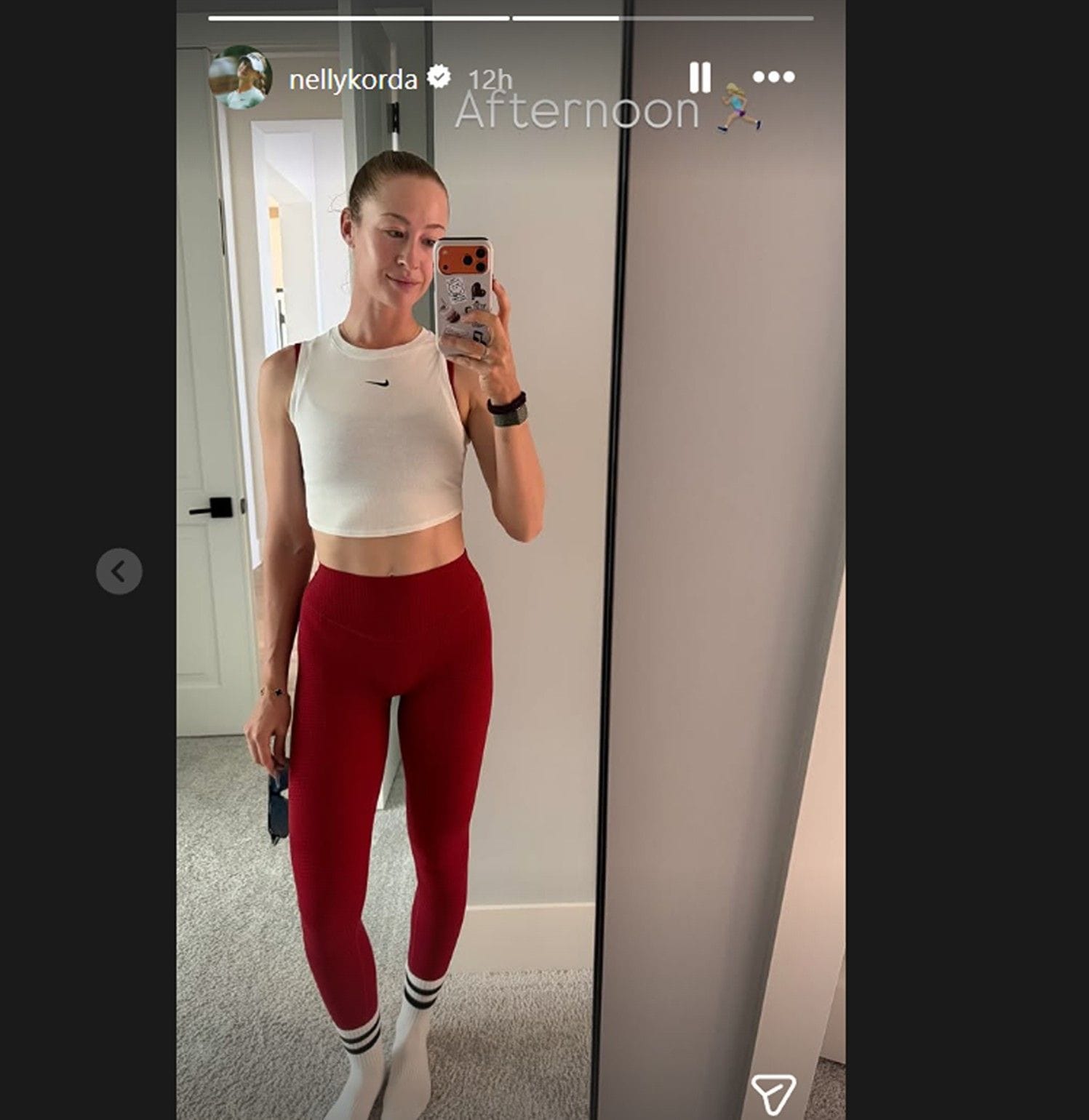 Nelly Korda poses in a  white cropped tank top in latest selfie