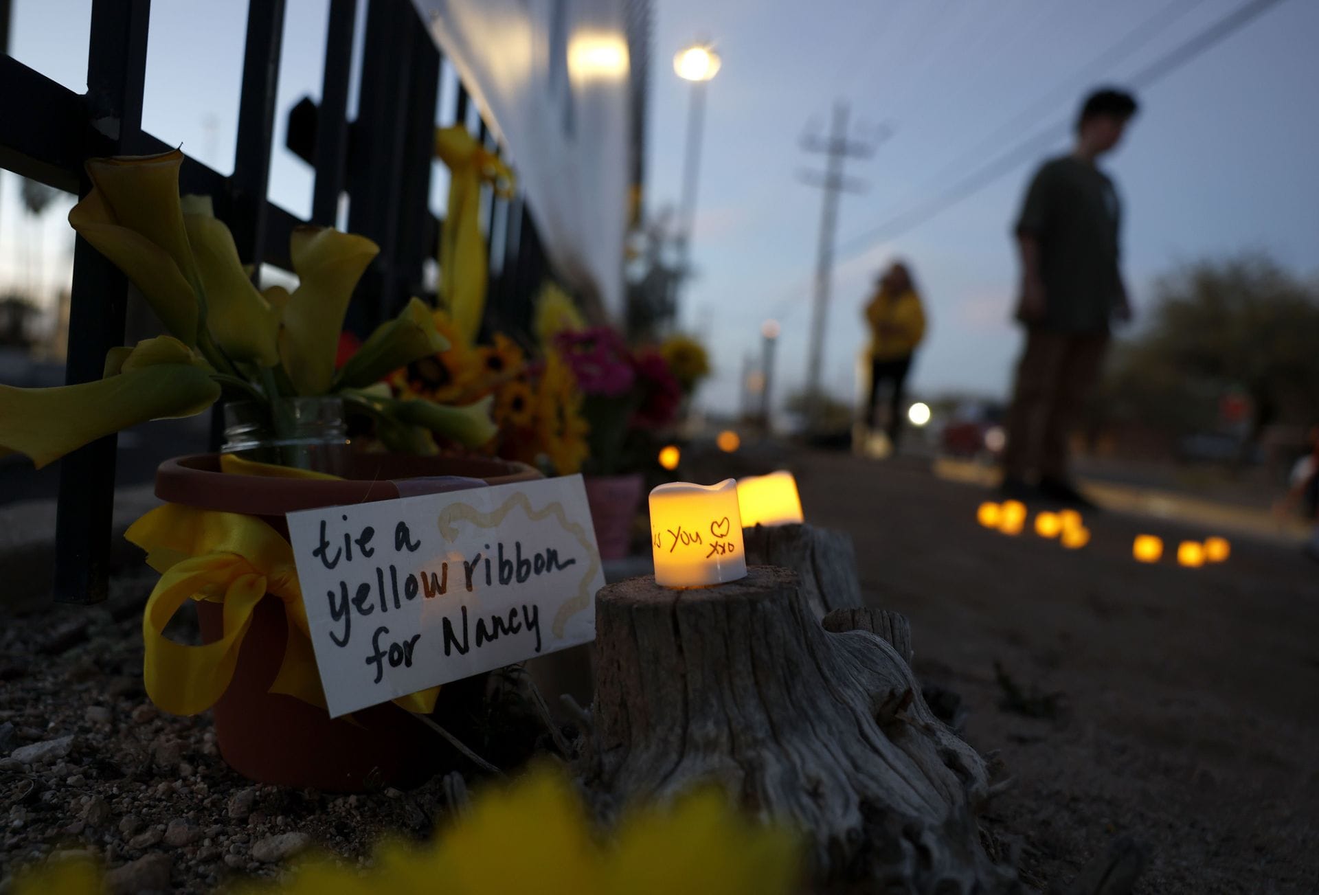 : Candles are placed at a makeshift memorial for Nancy Guthrie in front of the KVOA television station on March 01, 2026 in Tucson, Arizona (Image via Getty)