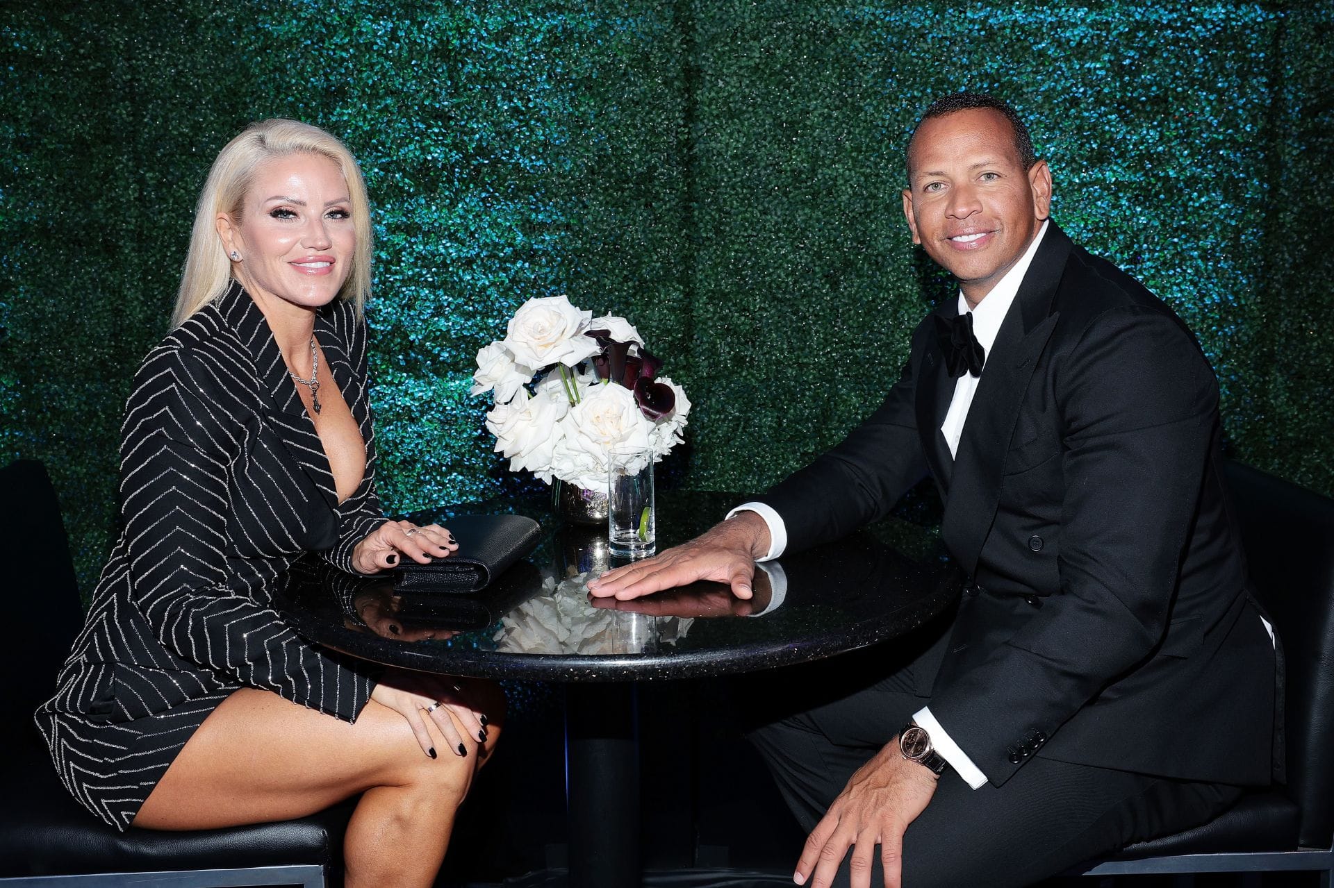 Alex Rodriguez's girlfriend Jaclyn Cordeiro poses in magenta pink fitted midi dress with Timberwolves dancer Yemi Ajagbe