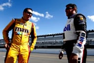 Kyle Busch, driver of the #18 M&M's Peanut Butter Toyota, left, talks with Tony Stewart, driver of the #14 Mobil 1/Bass Pro Shops Chevrolet, on the grid during qualifying for the NASCAR Sprint Cup Series Pocono 400 at Pocono Raceway on June 6, 2014 in Long Pond, Pennsylvania- Qualifying - Source: Getty