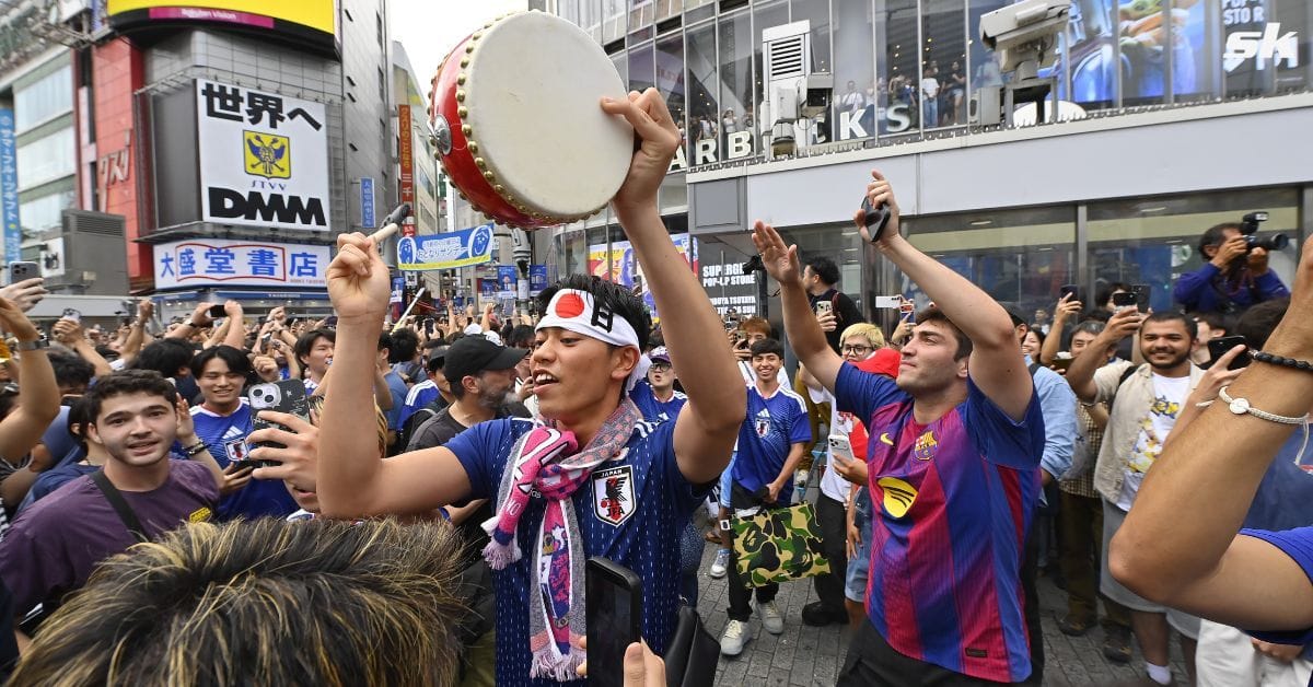 Japan fans celebrate FIFA World Cup win over Tunisia by taking over iconic Shibuya crossing in Tokyo