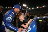 Kyle Larson, driver of the #5 HendrickCars.com Chevrolet, son, Owen Larson places the winner sticker on his car in victory lane after winning in victory lane after winning the NASCAR Cup Series Bass Pro Shops Night Race at Bristol Motor Speedway on September 21, 2024 in Bristol, Tennessee. - Source: Getty