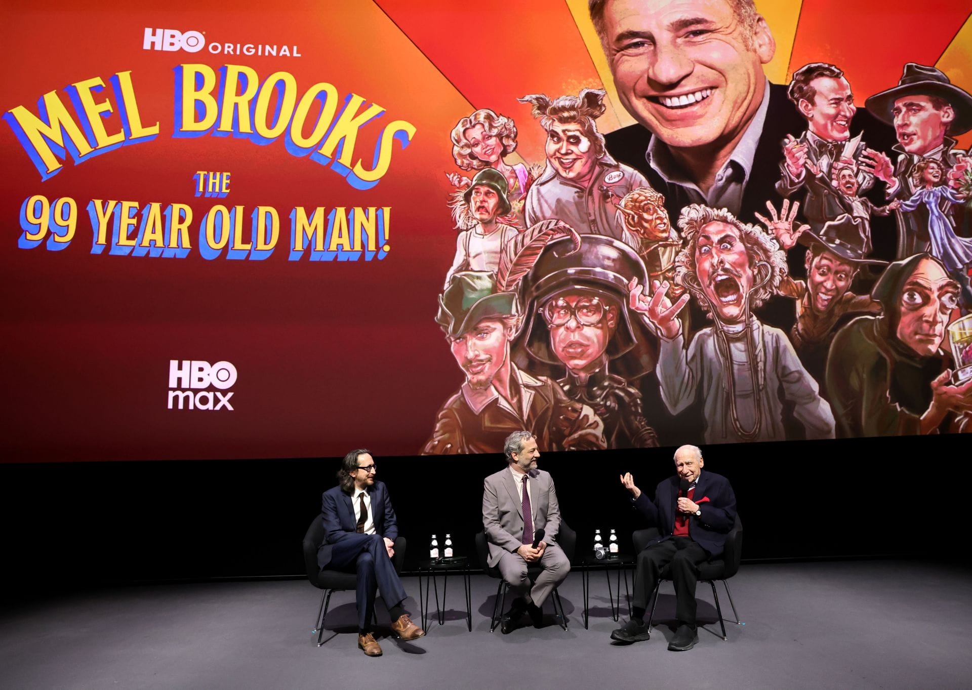 Michael Bonfiglio, Judd Apatow e Mel Brooks falam no palco durante a estreia em Los Angeles de "Mel Brooks: O homem de 99 anos!" no Academy Museum of Motion Pictures em 20 de janeiro de 2026 em Los Angeles, Califórnia. (Fonte: Getty)