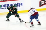 # 97 Kirill Kaprizov e # 8 lutando pelo disco durante um jogo - Fonte: Getty