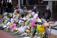 Flowers, candles, drinks and messages in memory of Ozzy Osbourne are left on the Black Sabbath Bridge bench on Broad Street on July 23, 2025 in Birmingham, England. (Source: Getty)