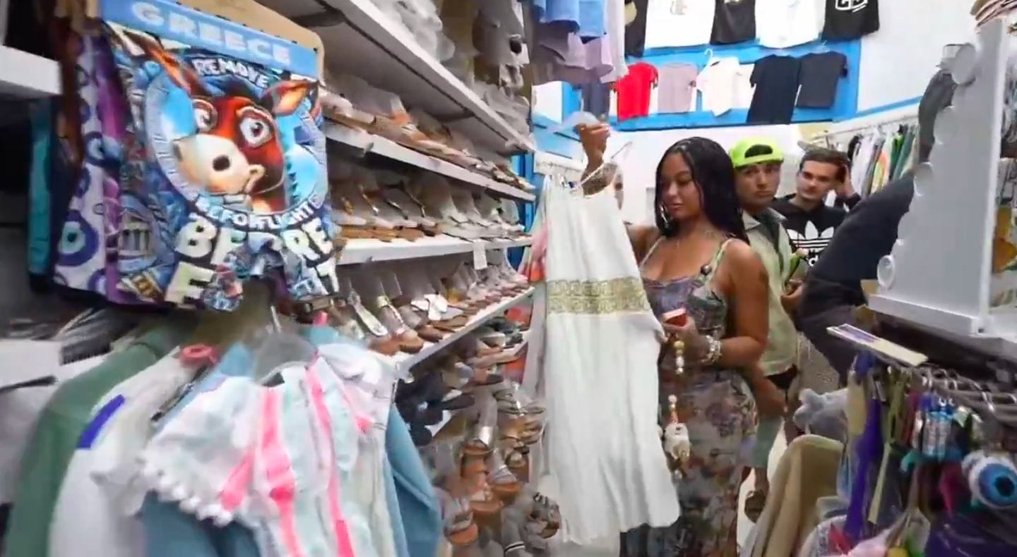 India Love appears uncomfortable after men approach and stare at her while shopping in Greece
