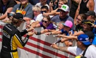 Racing fans reach for NASCAR Cup Series driver Carson Hocevar for an autograph at Indianapolis Motor Speedway. - Source: Imagn
