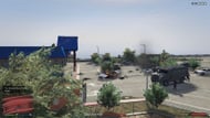 The shootout area with police and the target (Image via Rockstar Games || GTA Wiki)