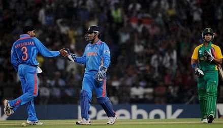 NAGPUR, INDIA - MARCH 12:  Harbhajan Singh of India celebrates with team mate MS Dhoni after the stumping of JP Duminy of South Africa during the Group B ICC World Cup Cricket match between India and South Africa at Vidarbha Cricket Association Ground on...