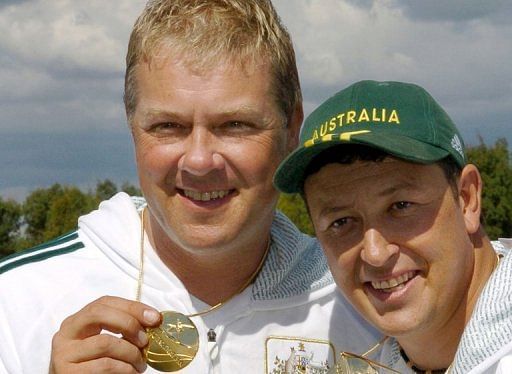 Russell Mark (L) and teammate Craig Trembath hold up gold medals at the 2006 Commonwealth Games
