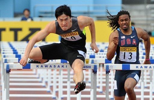 Liu (L) was forced out of the Beijing Olympics by an Achilles injury in front of a packed Bird&#039;s Nest Stadium