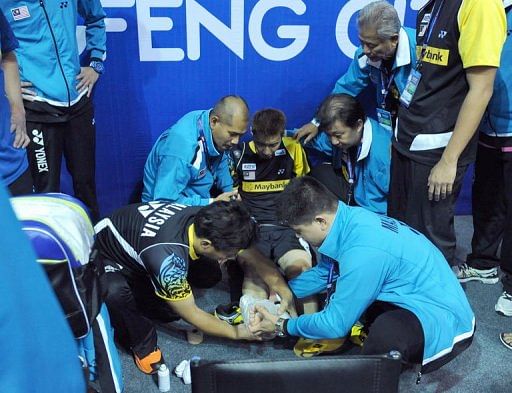 Lee Chong Wei of Malaysia receives medical attention
