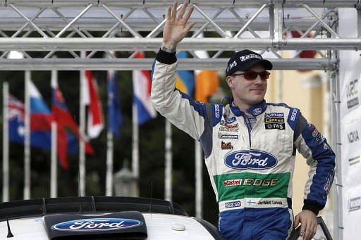 Jari-Matti Latvala of Finland stands next to his Ford Fiesta RS WRC