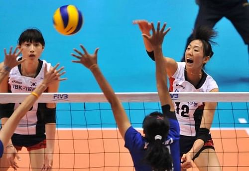 South Korea's Han Song-Yi (R) spikes the ball over Thailand's Kanthong Maika (2ndR)