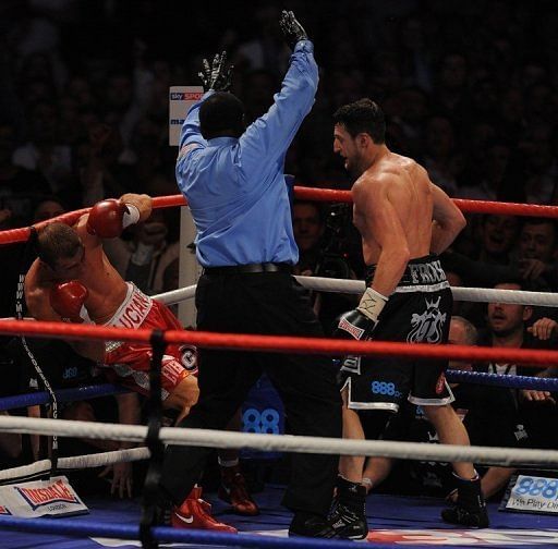 Carl Froch knocks down Lucian Bute to win their IBF super-middleweight title match in Nottingham