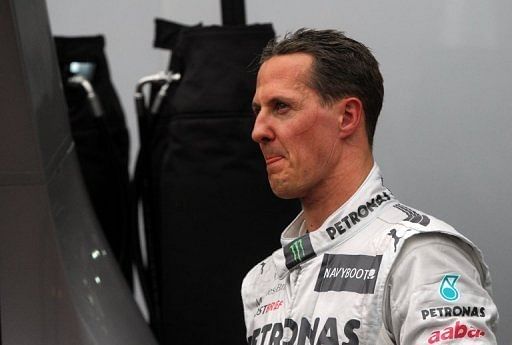 Mercedes&#039; driver Michael Schumacher walks through the pits after he was forced to retire from the Monaco Grand Prix