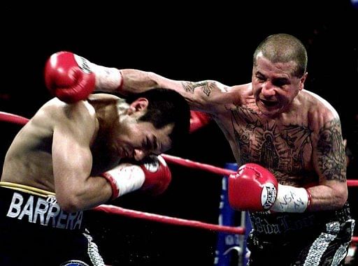 Johnny Tapia (R) earned world titles in the super flyweight, bantamweight and featherweight divisions during his career