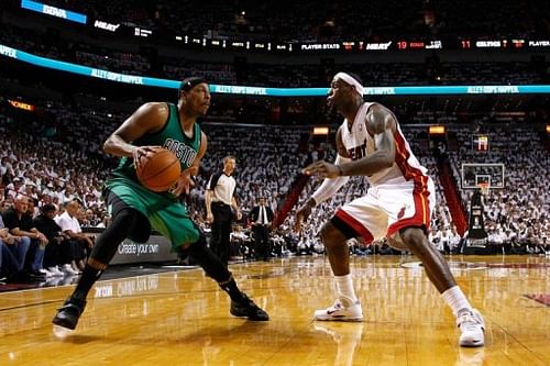 Boston Celtics' Paul Pierce (L) looks to pass the ball as Miami Heat's LeBron James defends