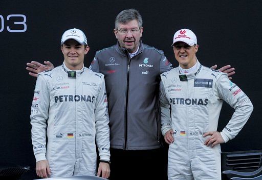 Michael Schumacher (right), Nico Rosberg (left) and team principal Ross Brawn pose