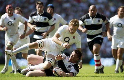 England&#039;s Jamie Gibson (C) fights for the ball against Barbarians&#039; Captain John Smit (bottom)