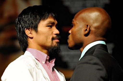 Boxers Manny Pacquiao (L) and Timothy Bradley pose during the final news conference
