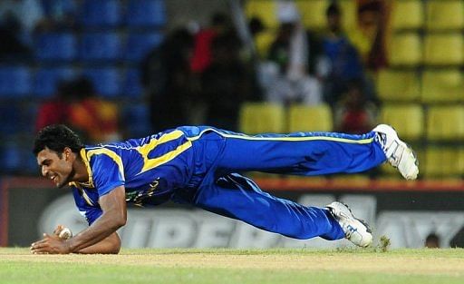Sri Lankan cricketer Thisara Perera takes a catch to dismiss Pakistan cricketer Mohammad Hafeez