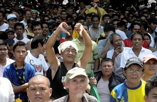 A fan in Manila give a thumbs down to protest Timothy Bradley&#039;s victory