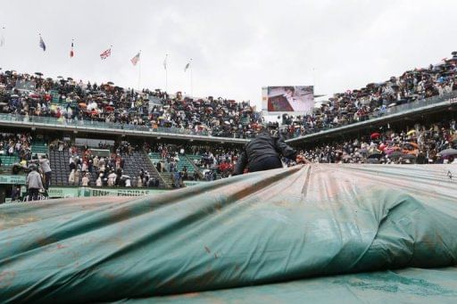 Staff members cover the Philippe Chatrier court