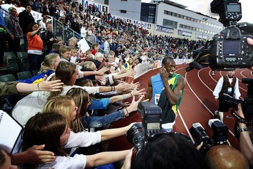 Usain Bolt (L) of Jamaica reacts after winning the men&#039;s 100m race at the IAAF Diamond League athletics meet