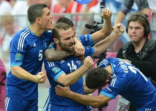 Greek forward Dimitris Salpingidis (C) celebrates with teammates after scoring against Poland