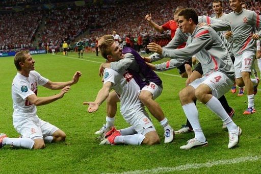 Polish midfielder Jakub Blaszczykowski (C) celebrates with teammates after scoring