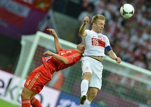 Russian defender Sergey Ignashevich (L) vies with Polish midfielder Jakub Blaszczykowski (R)