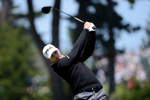 Michael Thompson of the United States watches his tee shot on the ninth hole