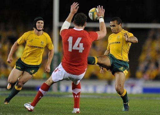 Australia&#039;s Will Genia from (right) kicks the ball during the second Test against Wales