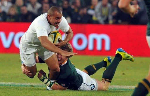 England&#039;s Jonathan Joseph (L) is tackled by a South African player