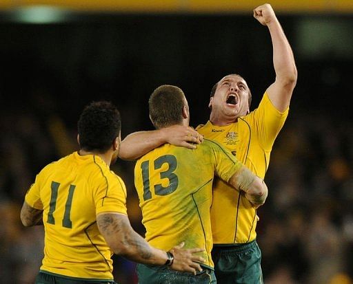 Australia&#039;s (L-R) Digby Ioane, Rob Horne and Ben Alexander celebrate after their win against Wales on June 16