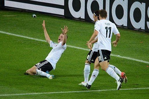German midfielder Lars Bender (L) is congratulated by teammates after scoring