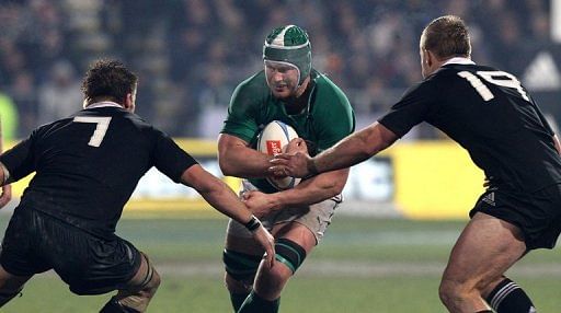 Ireland&#039;s Sean O&#039;Brian (C) is tackled by New Zealand captain Richie McCaw (L) and Sam Cane