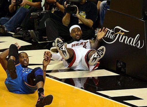 LeBron James (R) of the Miami Heat and Kevin Durant (L) of the Oklahoma City Thunder take a fall