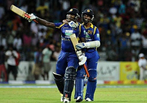 Sri Lankan cricketer Angelo Mathews (L) and Nuwan Kulasekara (R) celebrate after victory