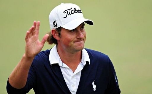 Webb Simpson of the US acknowledges the crowd after finishing at the 18th hole