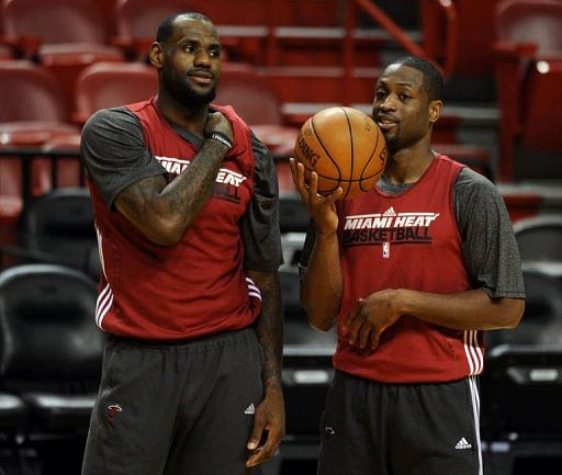 Miami Heat LeBron James (L) and Dwyane Wade talk during practice