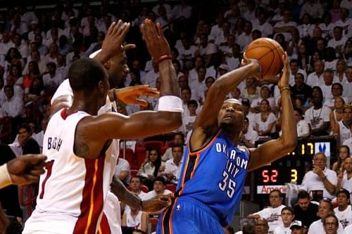 Oklahoma City Thunder's Kevin Durant attempts a shot as Miami Heat's Chris Bosh (L) defends during game four