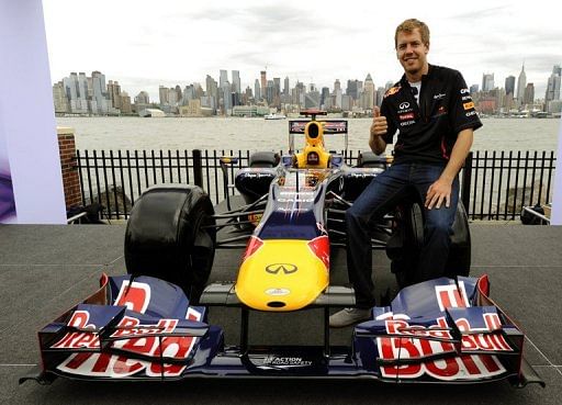 Sebastian Vettel poses on a Red Bull F1 car on June 11