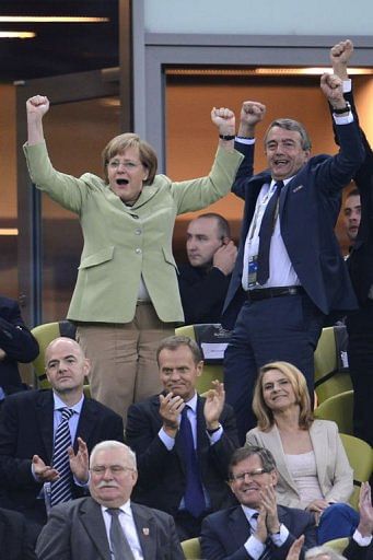 German Chancellor Angela Merkel and German football association president Wolfgang Niersbach (top R) celebrate