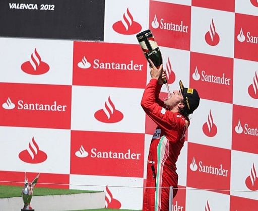 Ferrari&#039;s Spanish driver Fernando Alonso celebrates on the podium